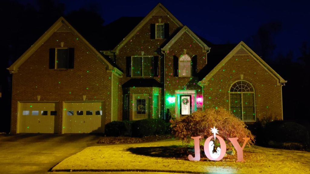 Laser lights and Christmas Joy yard sign
